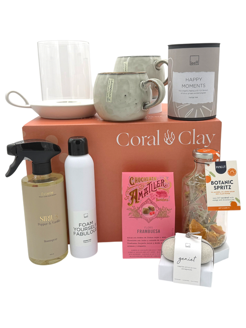 Collection of products including bottles, a mug, and a box with 'Coral & Clay' branding on a white background.