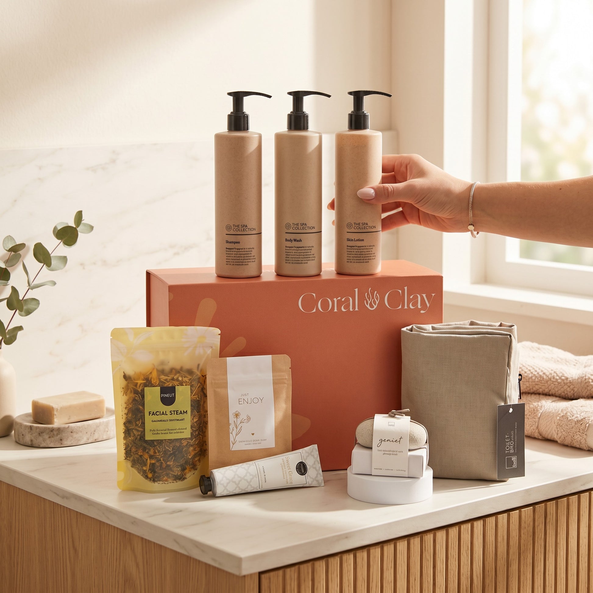 Coral & Clay bath retreat products on a counter with a hand reaching for one of the bottles.