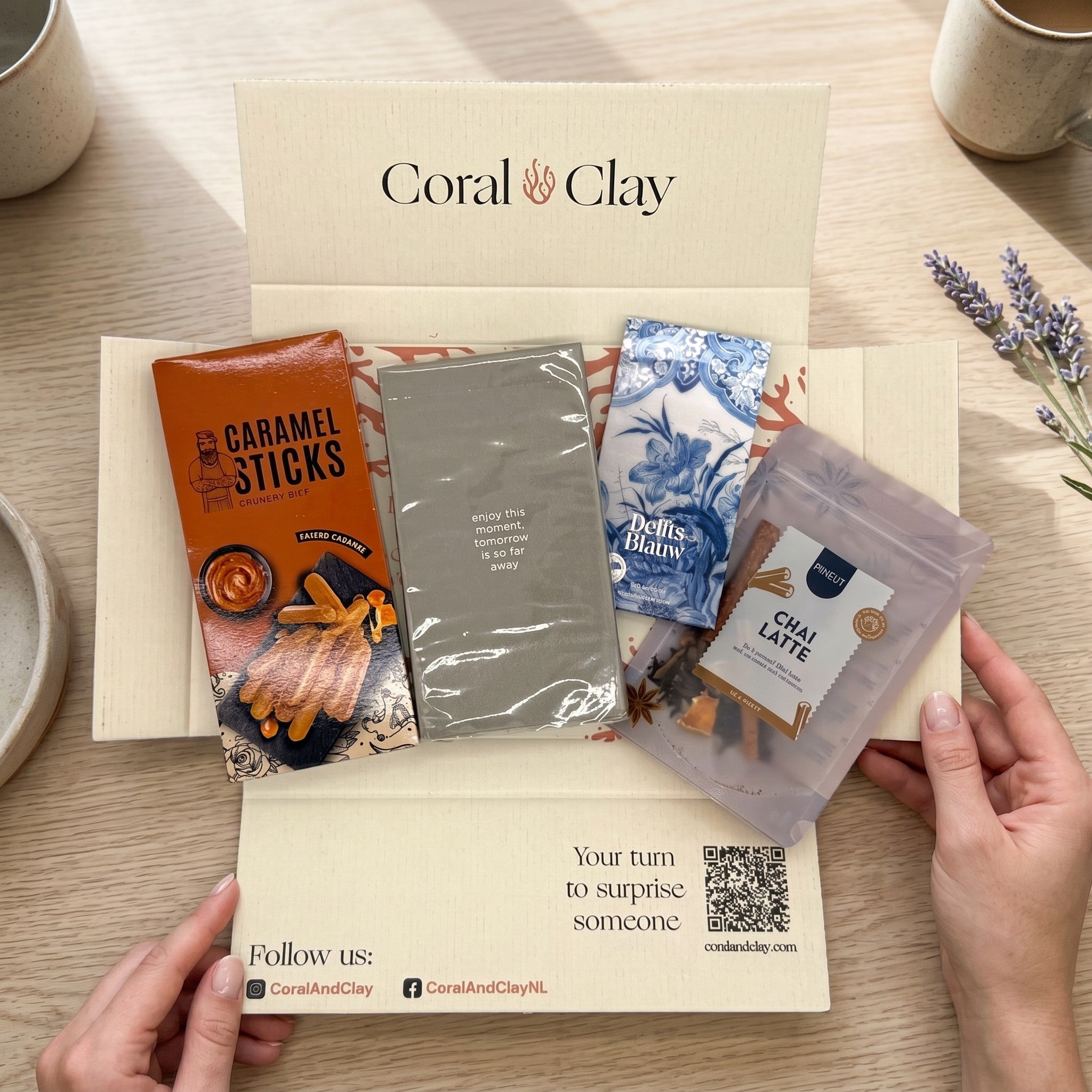 Coral & Clay Sunday Afternoon letterbox gift packaging photo – hands holding the chai & chocolate letterbox gift box on a wooden surface