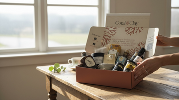 Coral & Clay gift box open on a wooden table with contents showing