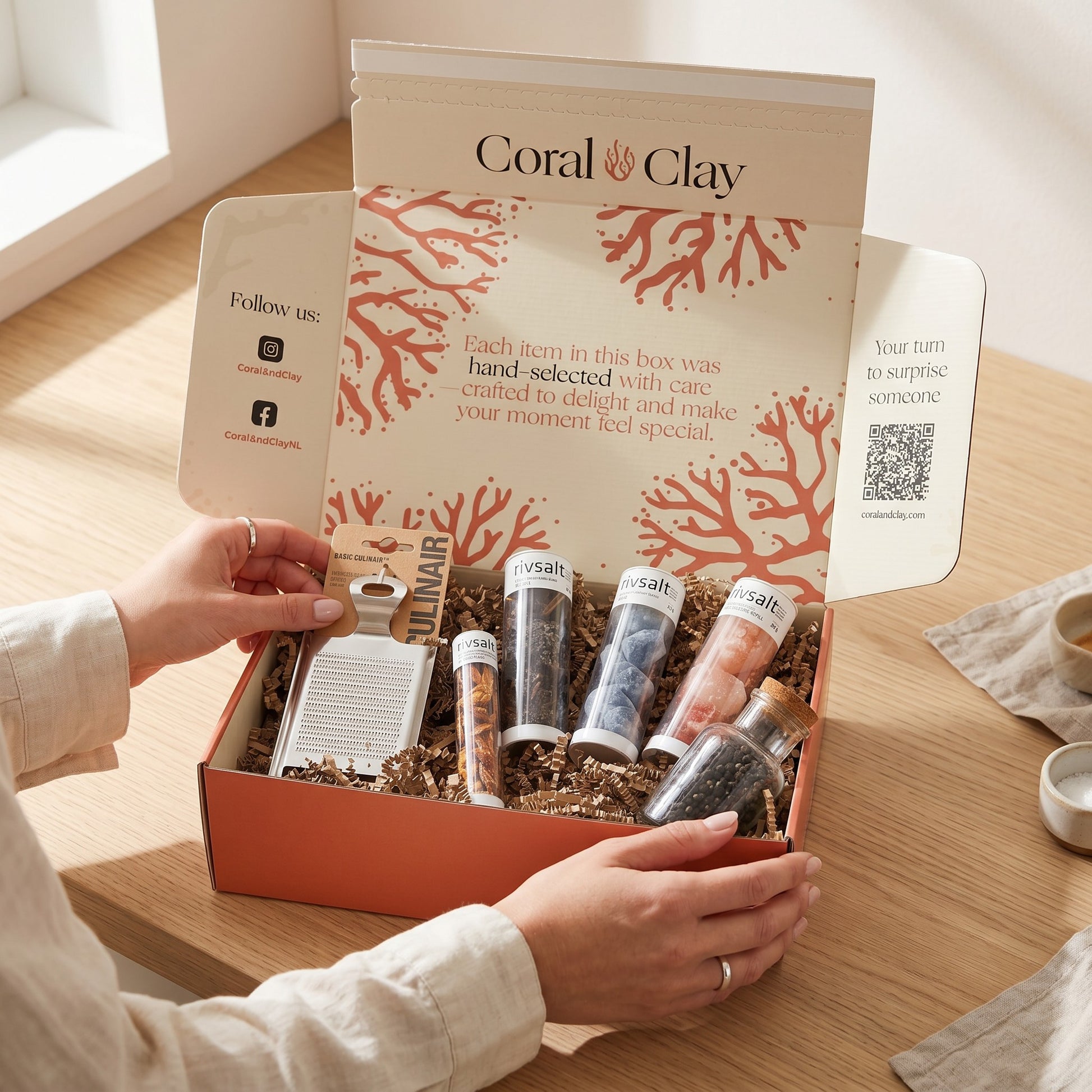 Coral & Clay Spiceworks Signature Gift lifestyle photo – terracotta signature gift box on a wooden surface with Rivsalt gourmet salt rocks, stainless-steel grater, Amazon Chili and Java Long Pepper.