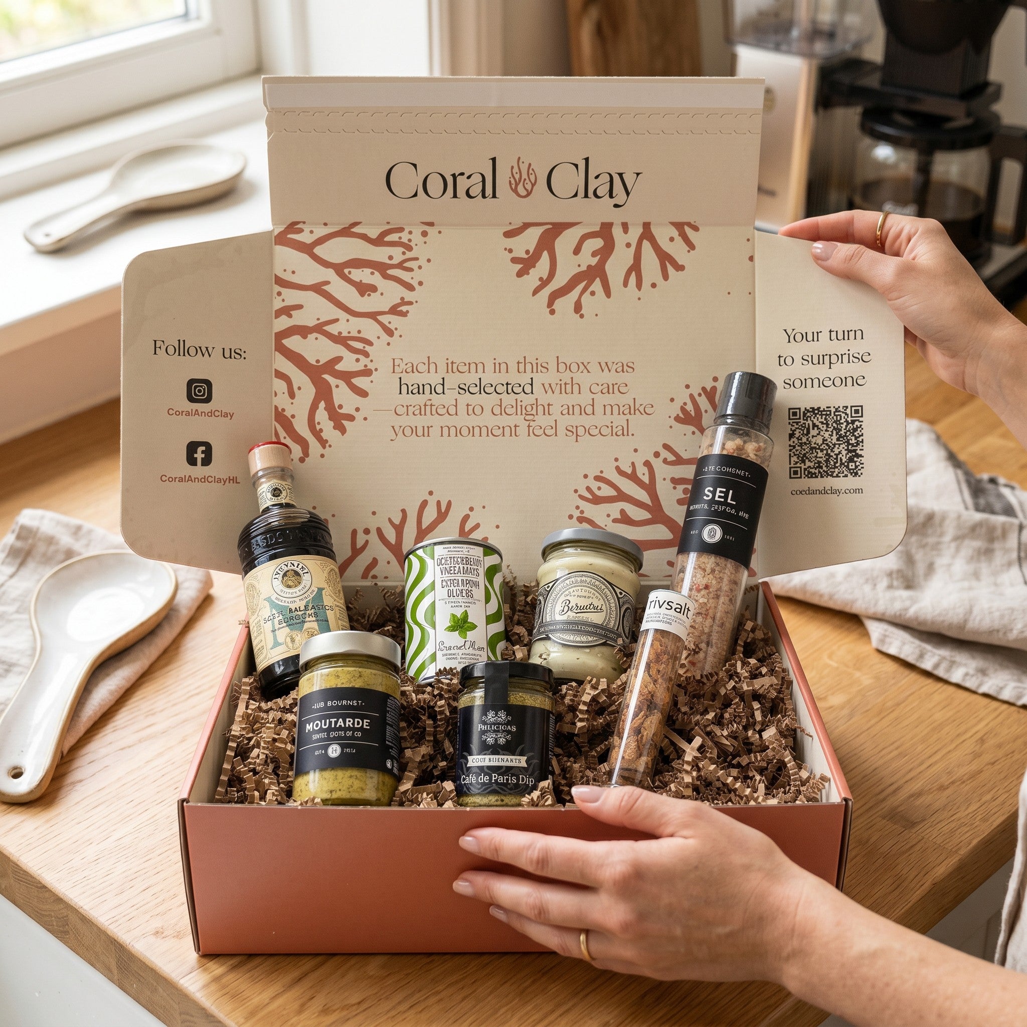 Coral Clay gift box with various items on a wooden surface