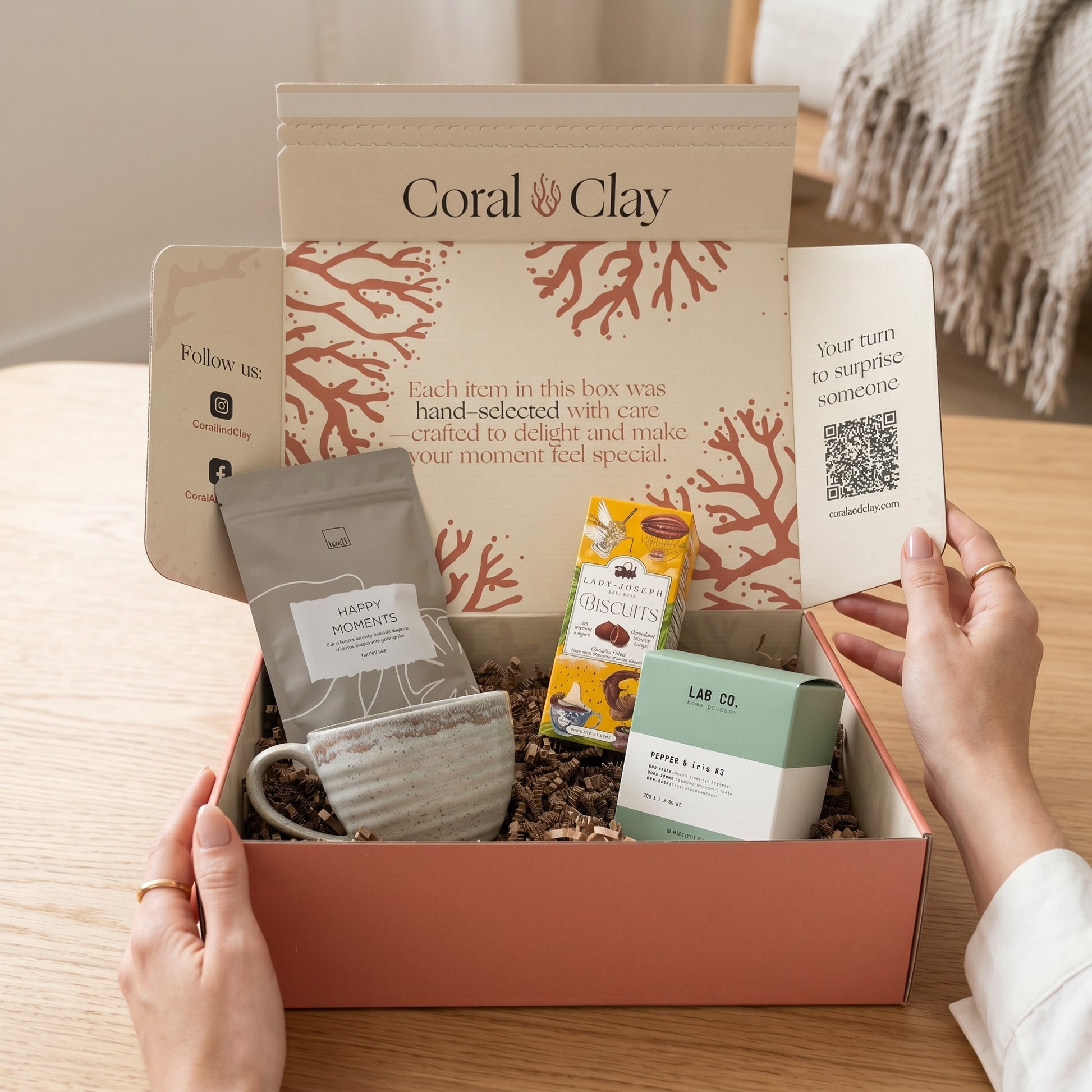 Coral Clay gift box with various items on a wooden surface