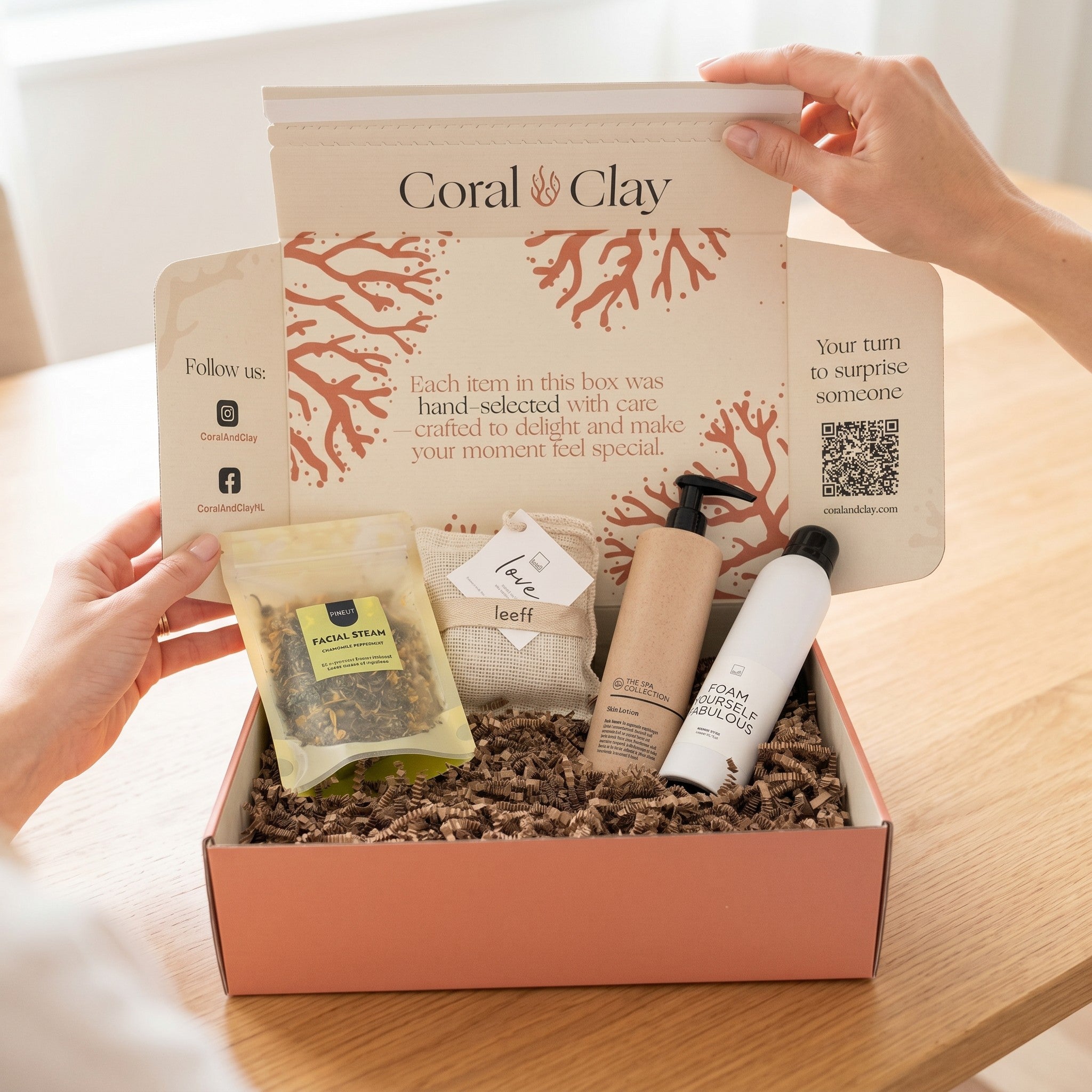 Coral Clay gift box with various items on a wooden surface