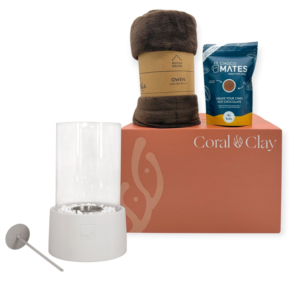 Coral & Clay grand gift box with a LEEFF tabletop fireplace, dark brown Dutch Decor Owen blanket and Choco Mates hot chocolate mix arranged neatly on top of the box against a clean white background.
