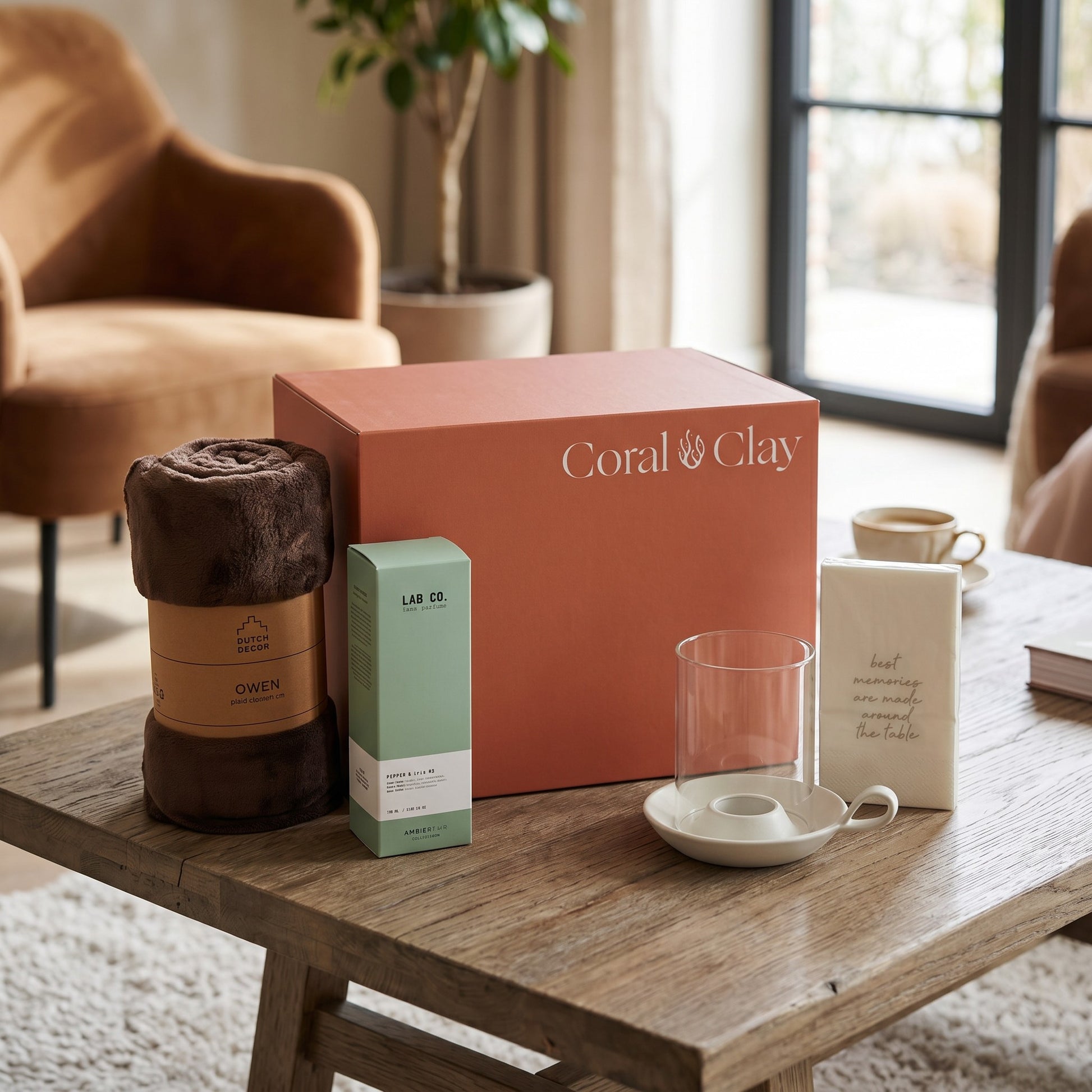Coral & Clay product packaging on a wooden table with decorative items in a home setting