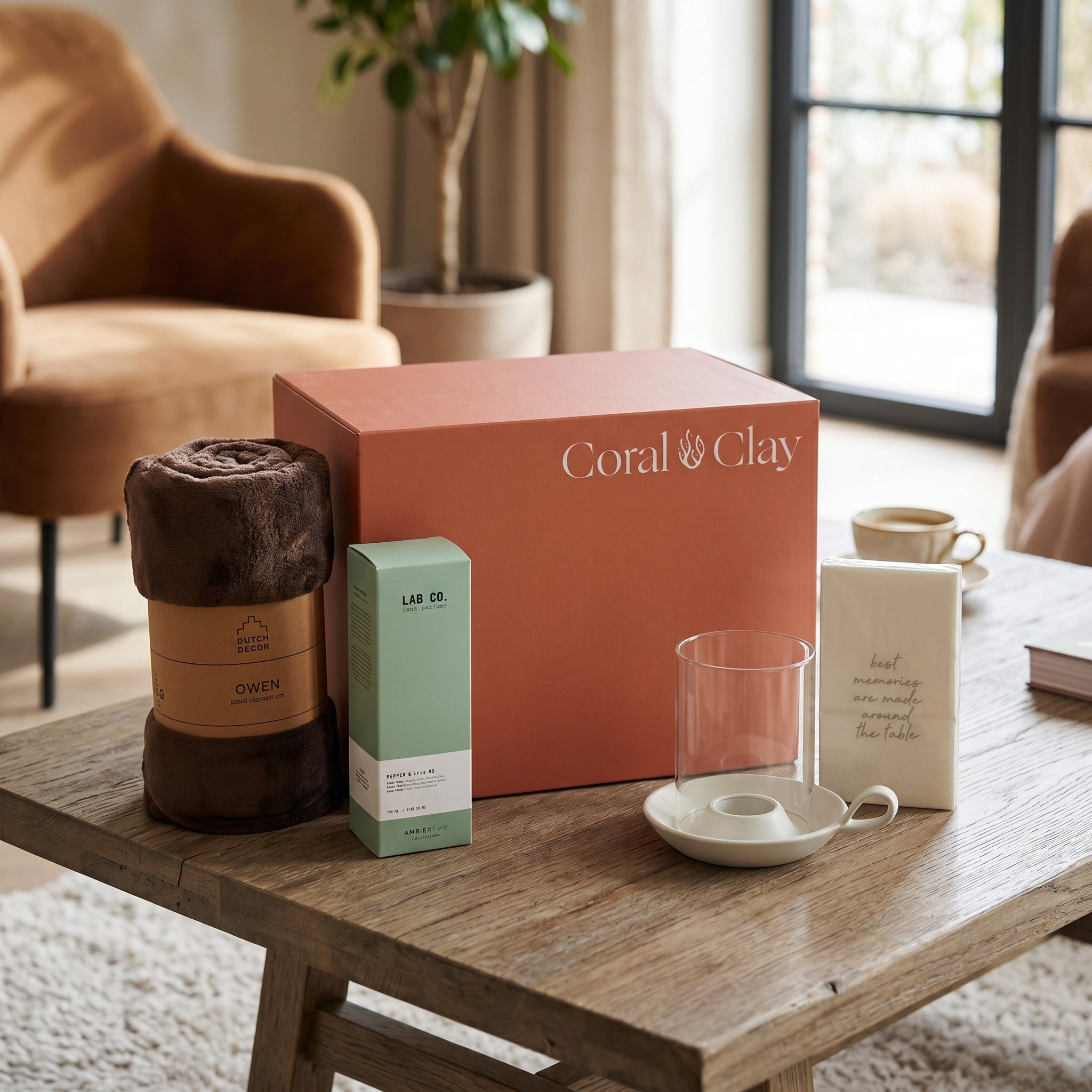 Coral & Clay product packaging on a wooden table with decorative items in a home setting
