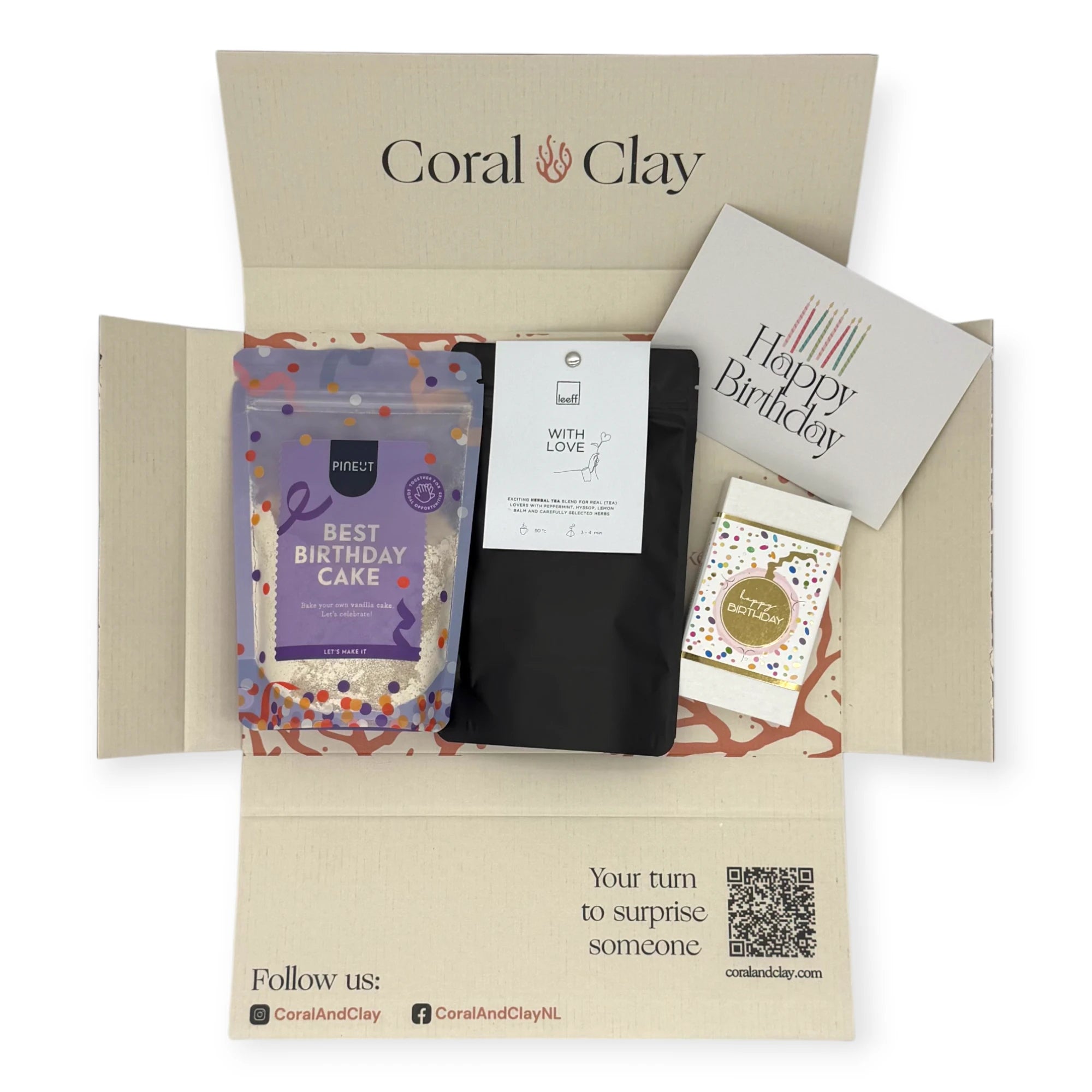Top-down view of the Coral & Clay Birthday Moments Letterbox Gift opened to reveal Best Birthday Cake mix, With Love herbal tea, birthday chocolate bar, and greeting card inside the printed box.