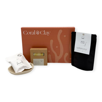 Coral & Clay Body & Mind Letterbox Gift displayed with Leeff Luck sachet, Box of Warmth soap bar, ceramic dish, and With Love herbal tea.