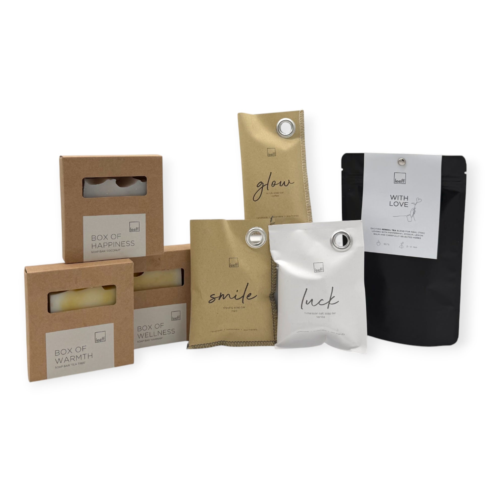 Contents of the Coral & Clay Body & Mind Letterbox Gift featuring Leeff scented sachets, artisan soap bars, a ceramic dish, and With Love herbal tea.