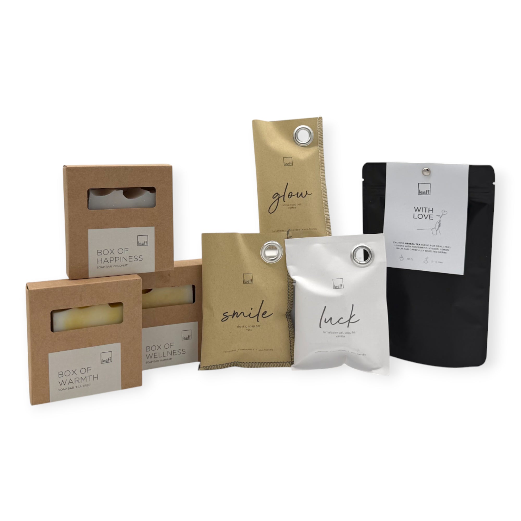 Contents of the Coral & Clay Body & Mind Letterbox Gift featuring Leeff scented sachets, artisan soap bars, a ceramic dish, and With Love herbal tea.