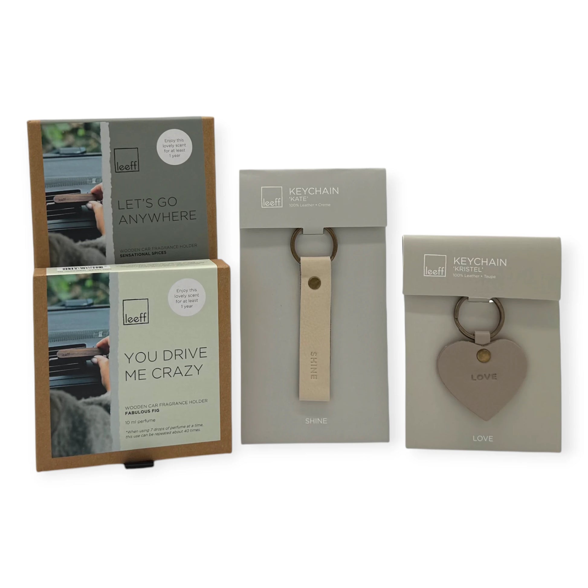 Contents of the Coral & Clay On the Go Letterbox Gift featuring Leeff wooden car fragrance holders and leather keychains in neutral tones.