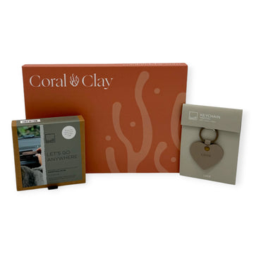 Coral & Clay On the Go Letterbox Gift displayed with a Leeff car fragrance holder and a heart-shaped leather keychain.