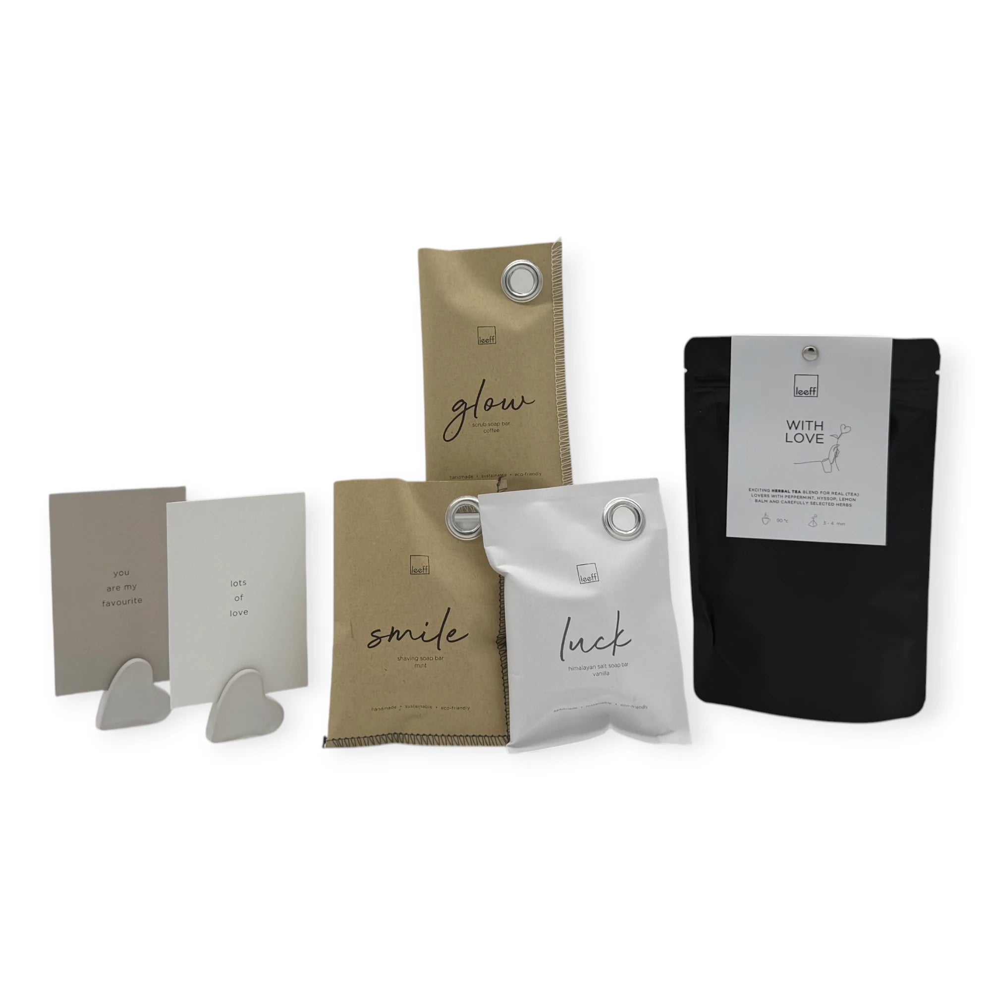 Contents of the Coral & Clay With Love Letterbox Gift, featuring Leeff sachets, herbal tea, and minimalist message cards with ceramic heart stands.