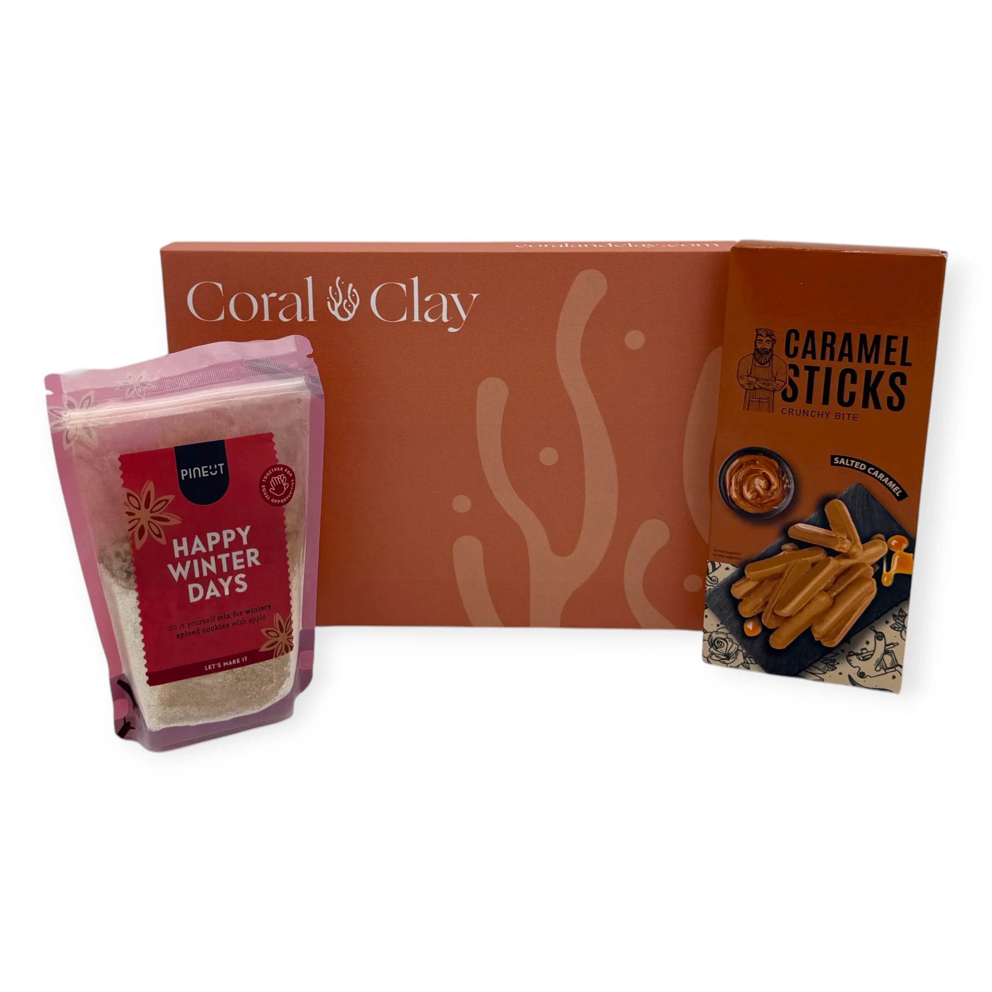 Coral & Clay Winter Treats Letterbox Gift displayed with Pineut Happy Winter Days cookie mix and salted caramel crunchy sticks.