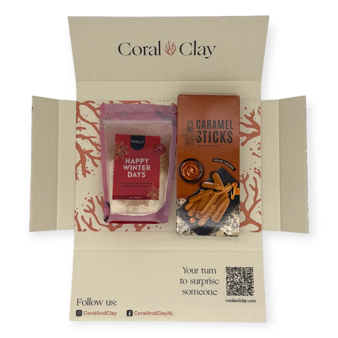 Coral & Clay Winter Treats Letterbox Gift displayed with Pineut Happy Winter Days cookie mix and salted caramel crunchy sticks.