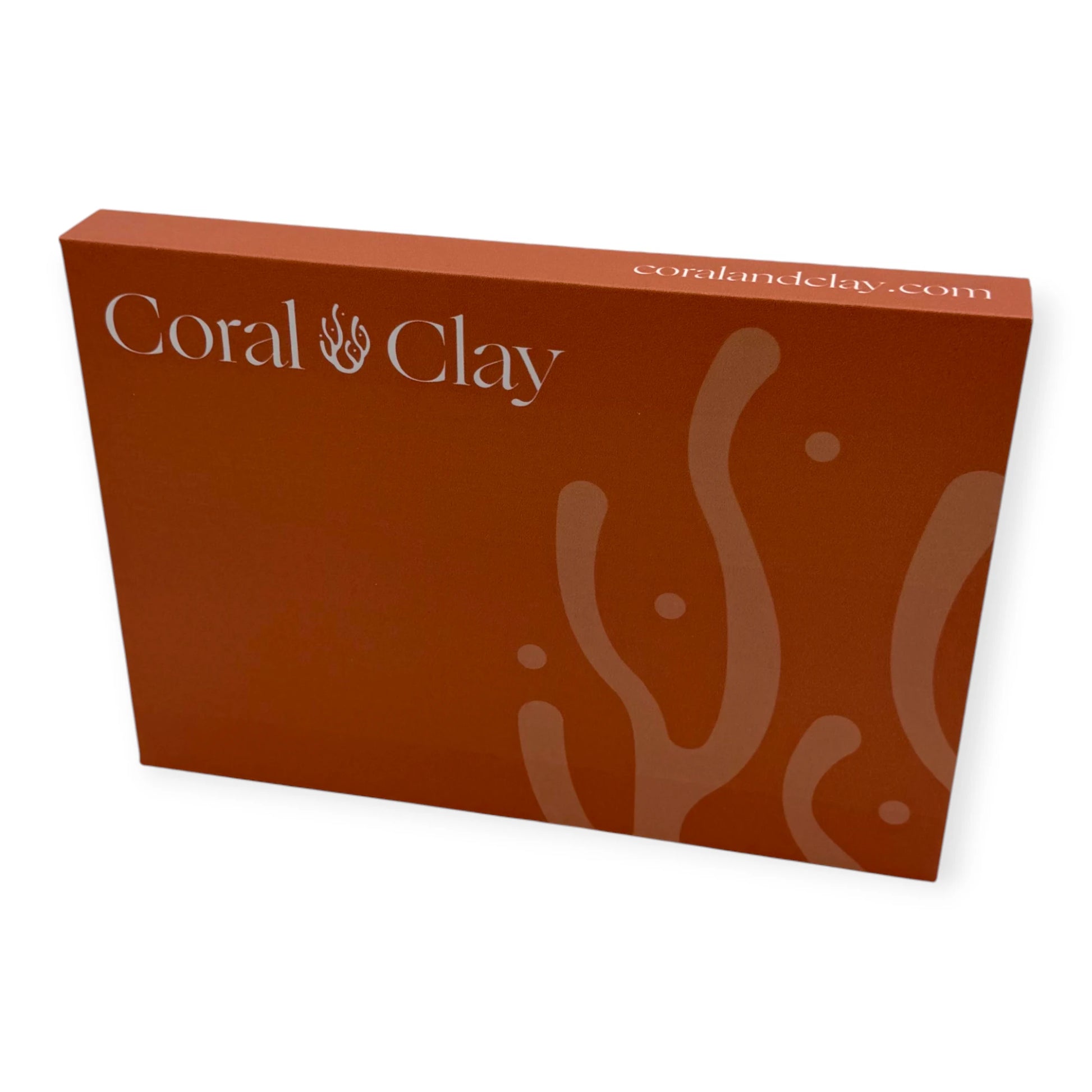Coral & Clay premium letterbox gift packaging in coral red with logo and abstract coral pattern.