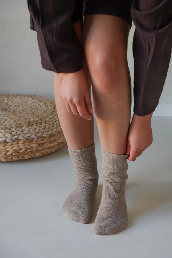 Leeff Warm Hug wool socks in sand worn at home.