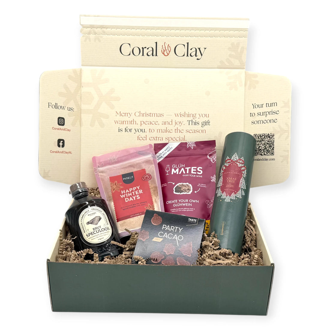 Christmas Scents Signature Gift displayed with Coral & Clay Christmas box and winter treats: glühwein mix, festive cookie mix, speculoos syrup, Christmas tree diffuser, and milk-chocolate Party Cacao shapes.”