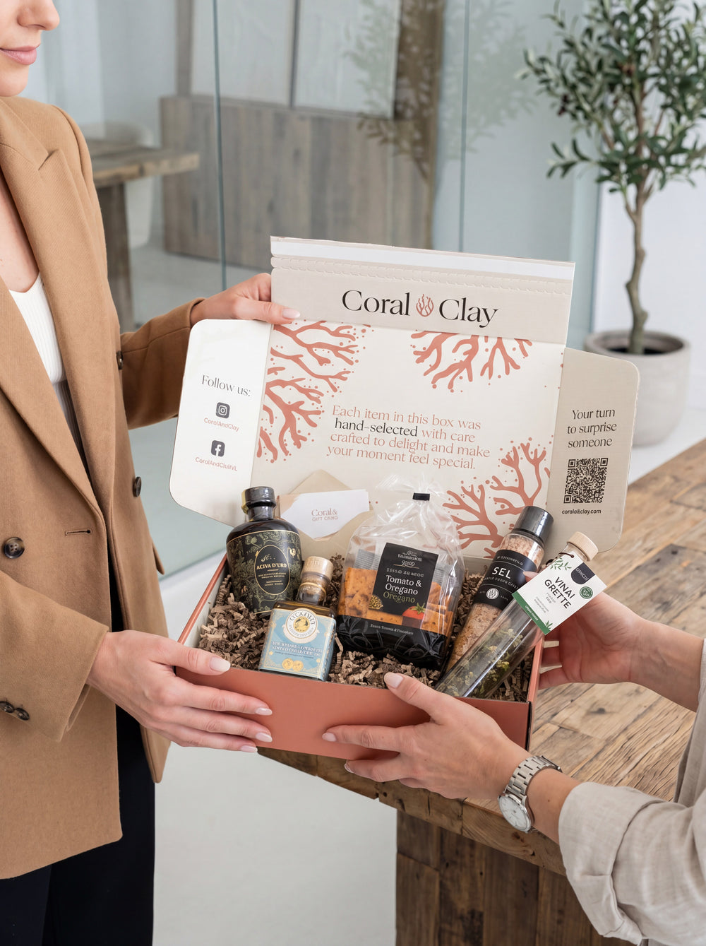 Corporate client receiving a branded Coral & Clay gift box in a professional setting