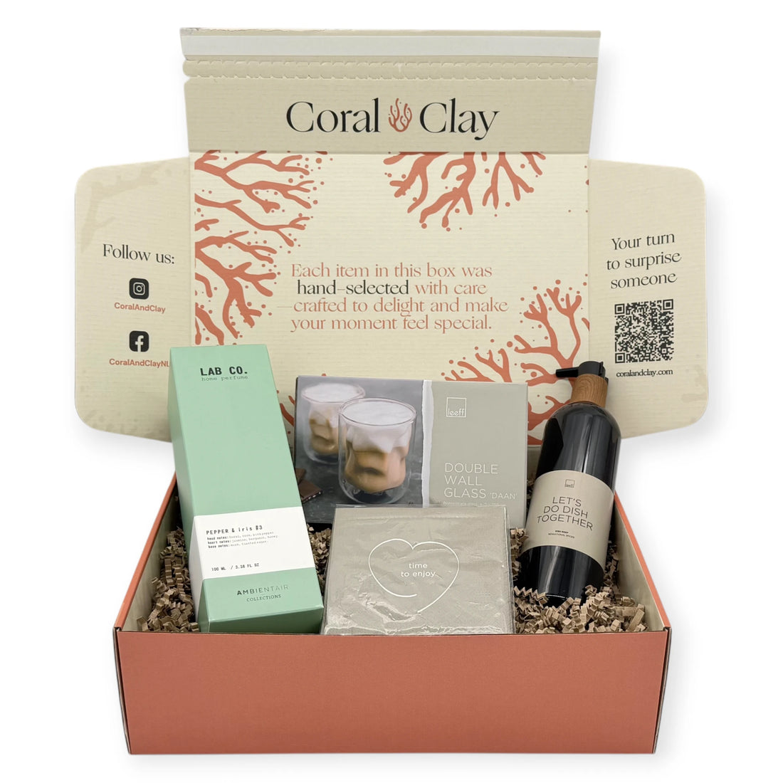 Home Haven Signature Gift displayed in front of a Coral & Clay Signature box, featuring napkins, double-wall glasses, Pepper & Iris home perfume, and dish soap.