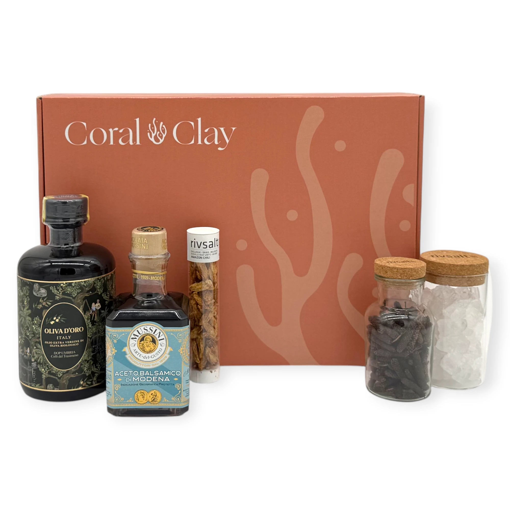 Premium Kitchen Essentials Signature Gift Box with gourmet olive oil, balsamic vinegar, Rivsalt seasonings, and artisan spices arranged in front of the Coral & Clay gift box.