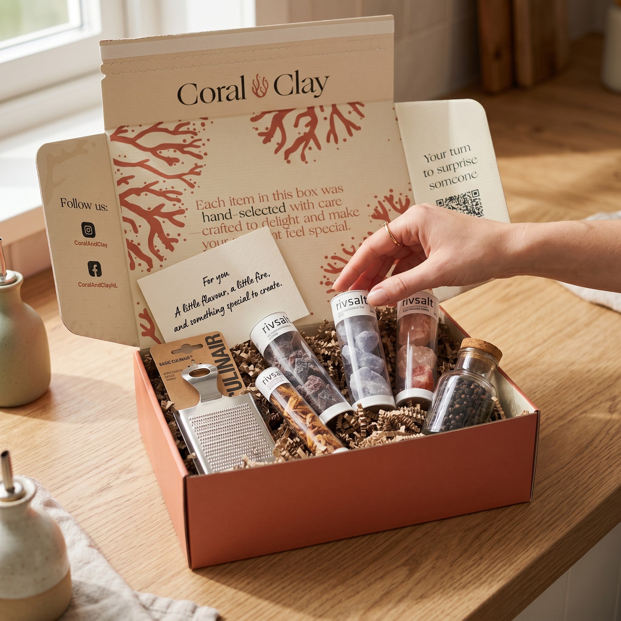 Coral Clay gift box with various items on a wooden surface