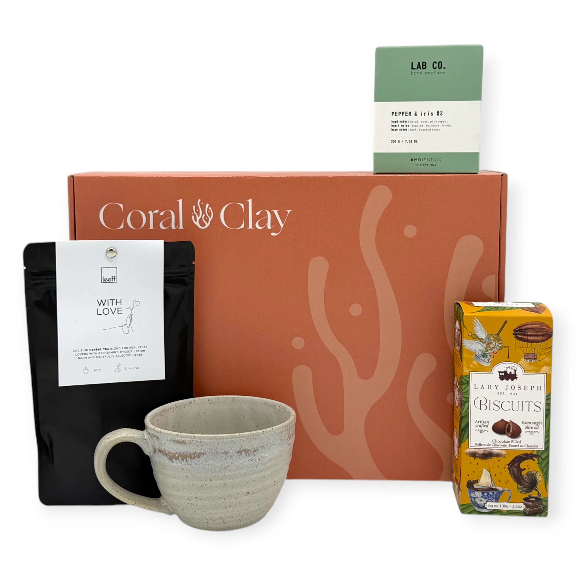 Tea Time Signature Gift displayed in front of a Coral & Clay Signature box, including herbal tea, home fragrance, artisan biscuits, and a handcrafted ceramic mug.