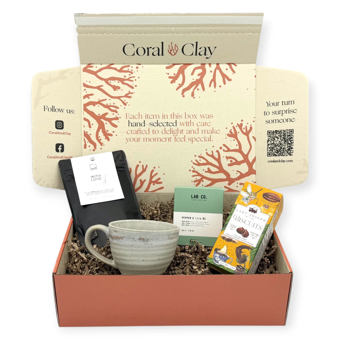 Tea Time Signature Gift displayed in front of a Coral & Clay Signature box, including herbal tea, home fragrance, artisan biscuits, and a handcrafted ceramic mug.