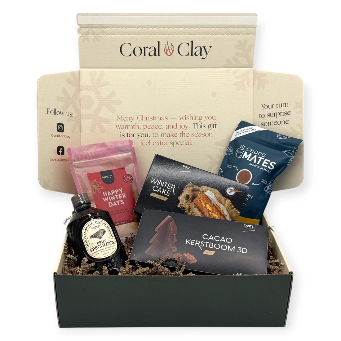 Coral & Clay Winter Sweets Signature Gift Box in deep green with all products arranged around it: Winter Cake mix, Speculoos liqueur, Choco Mates hot chocolate balls, Happy Winter Days cookie mix, and 3D milk chocolate Christmas tree.